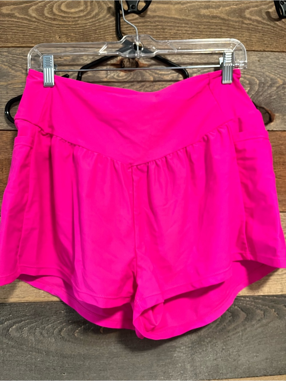 Women’s High-Waist Hot Pink Athletic Shorts with side pocket.